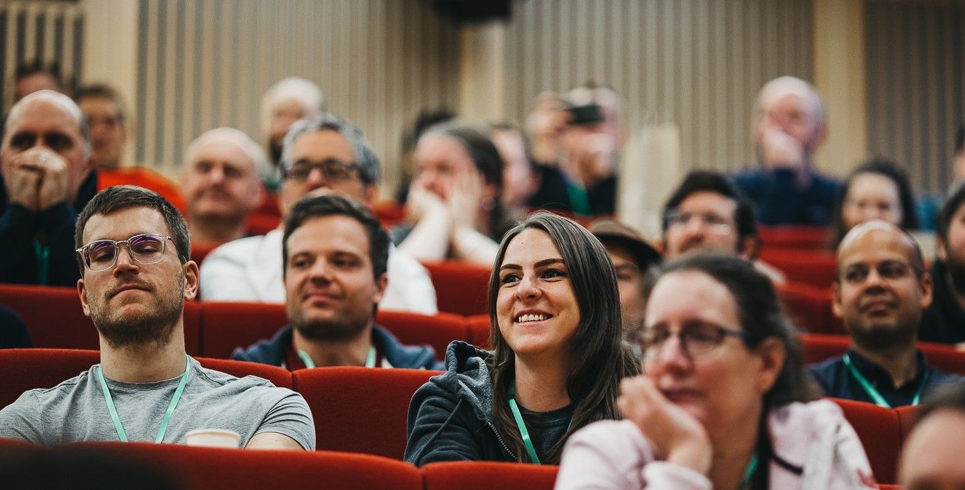 Image of the attendees of DDD East Midlands Conference 2019 seated in red auditorium seating.